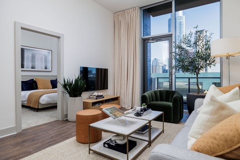 a living room with a large window and a couch and a table